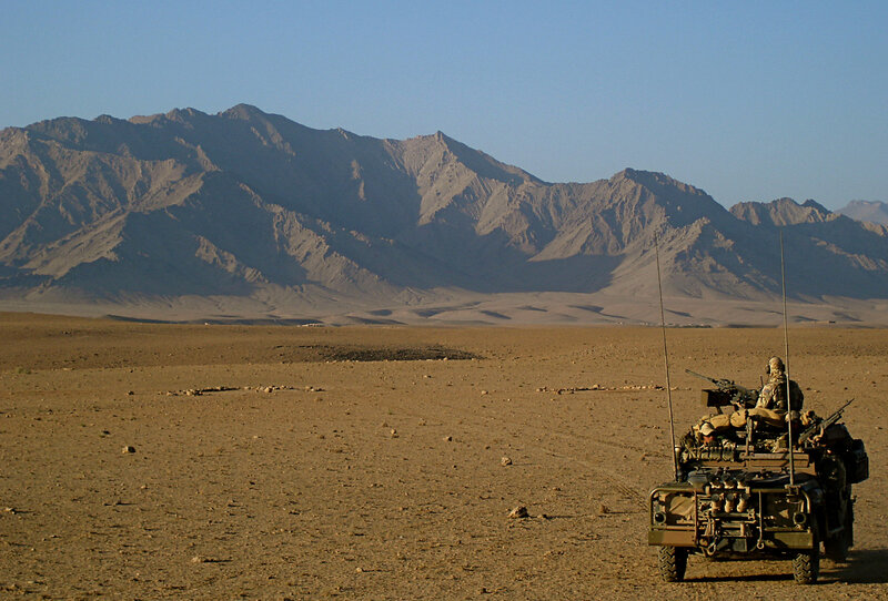 Military vehicle in desert landscape