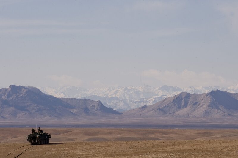Military vehicle in desert landscape