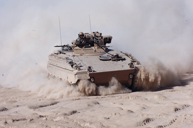Military vehicle in desert terrain