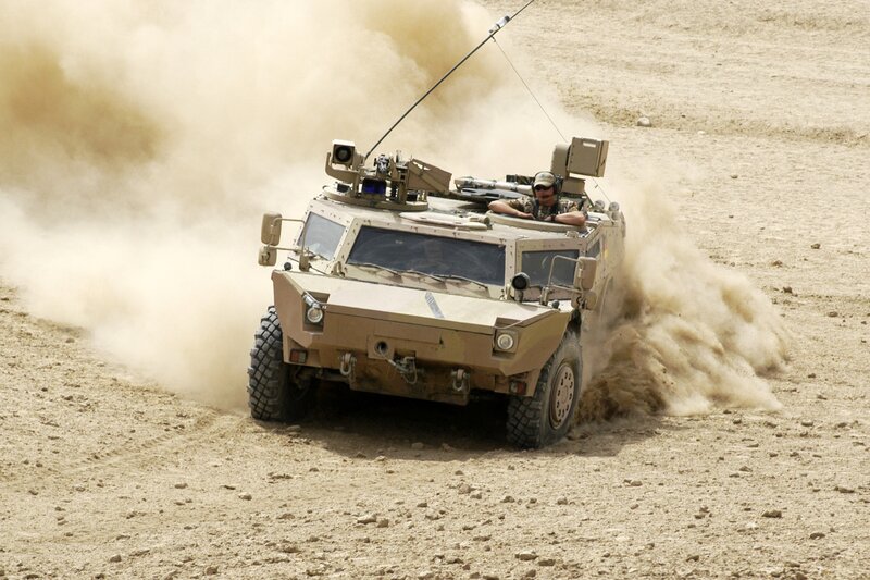 Military vehicle in desert terrain