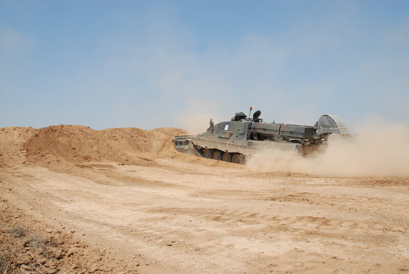 Military vehicle in desert terrain