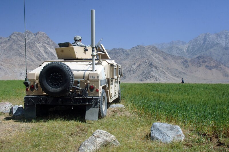 Military vehicle in mountain field