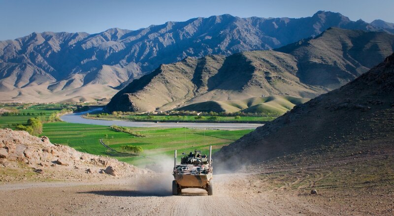 Military vehicle in mountain valley
