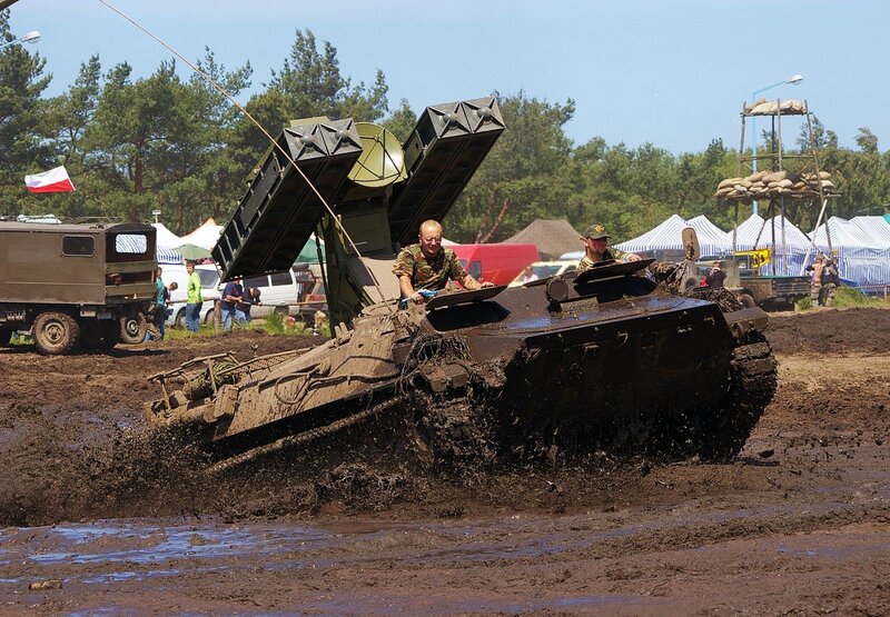 Military vehicle in muddy terrain