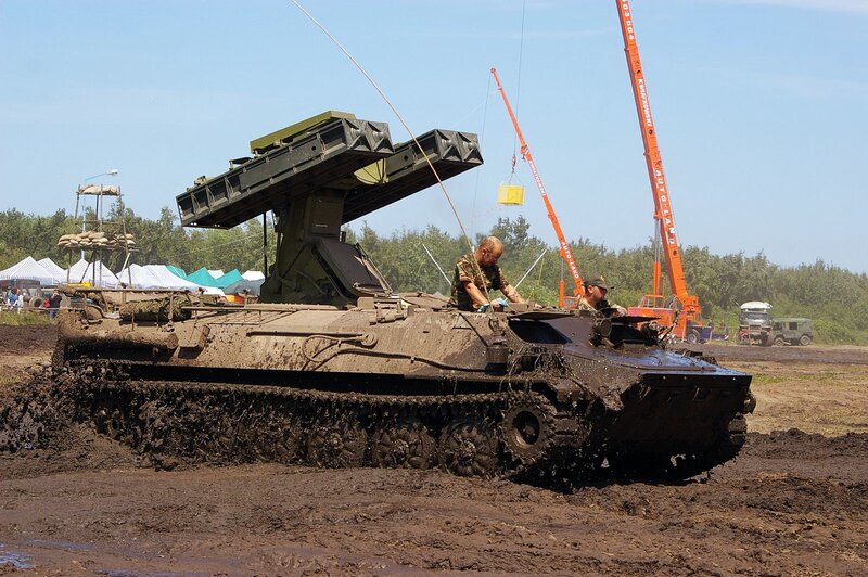 Military vehicle in muddy terrain