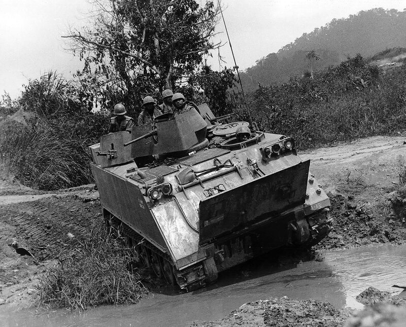 Military vehicle in muddy terrain
