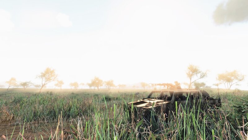 Military vehicle in tall grass