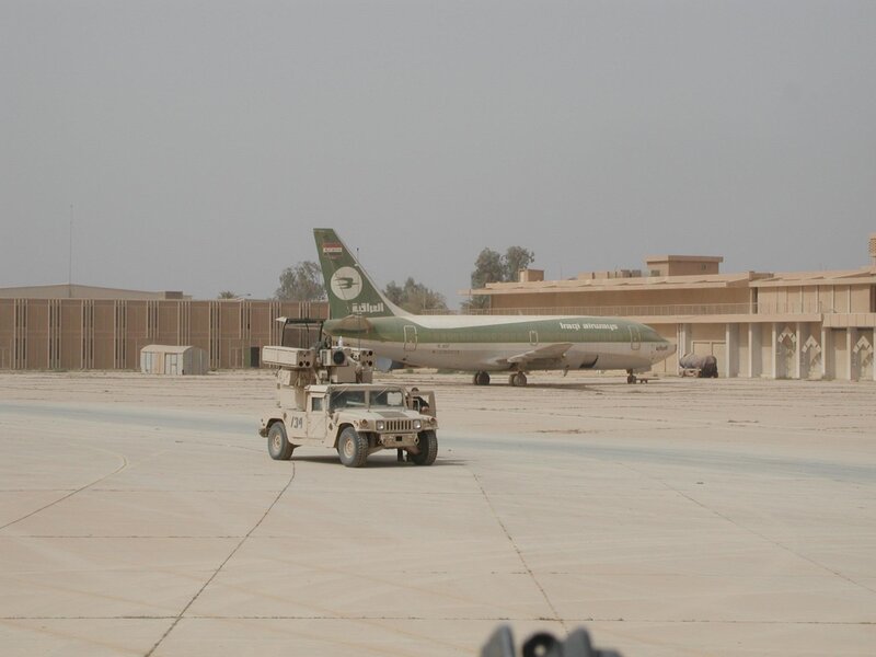 Military vehicle near Iraqi Airways plane