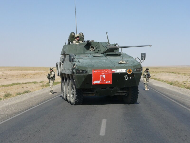 Military vehicle on desert road