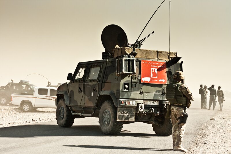 Military vehicle on desert road