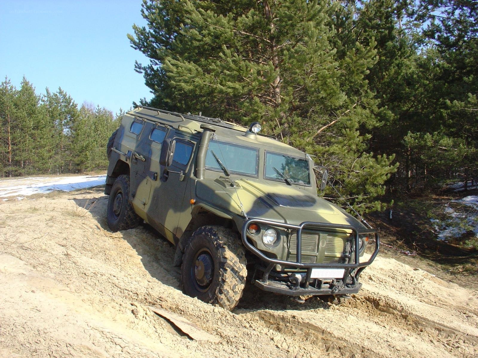 Military vehicle on dirt path