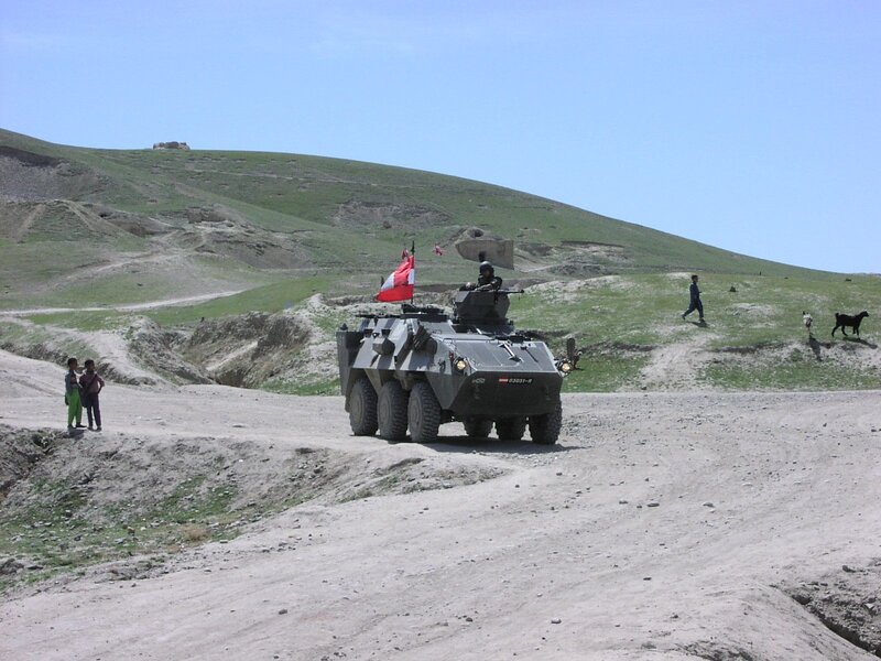 Military vehicle on dirt road
