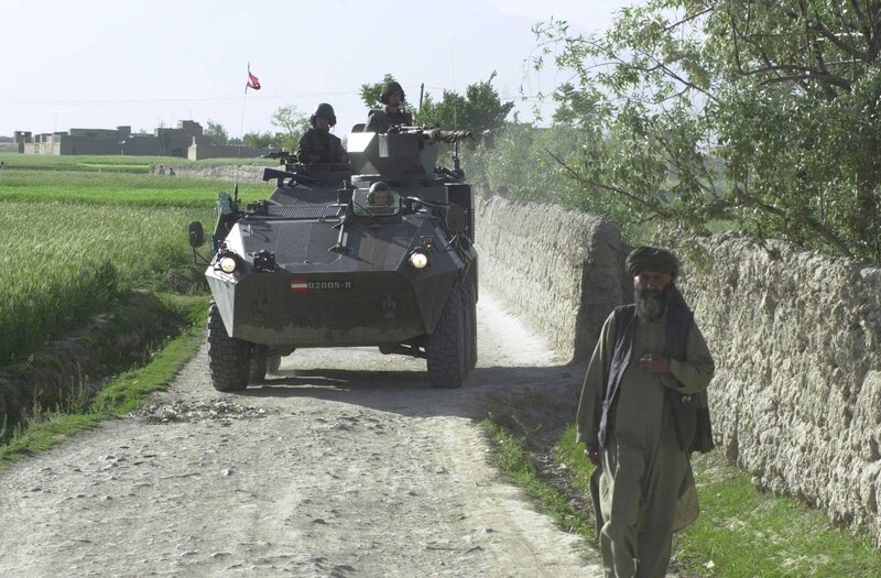 Military vehicle on rural road
