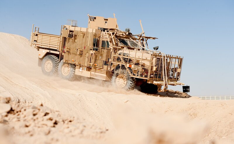 Military vehicle on sand dune