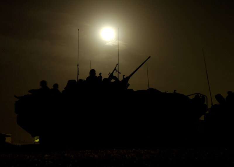 Military vehicle silhouette at night