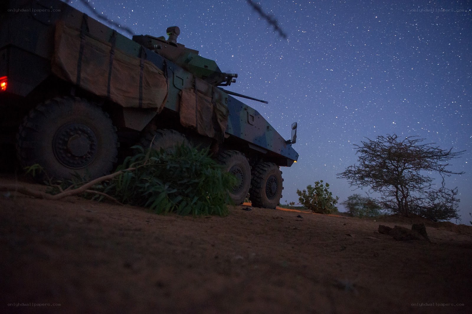 Military vehicle under starry sky