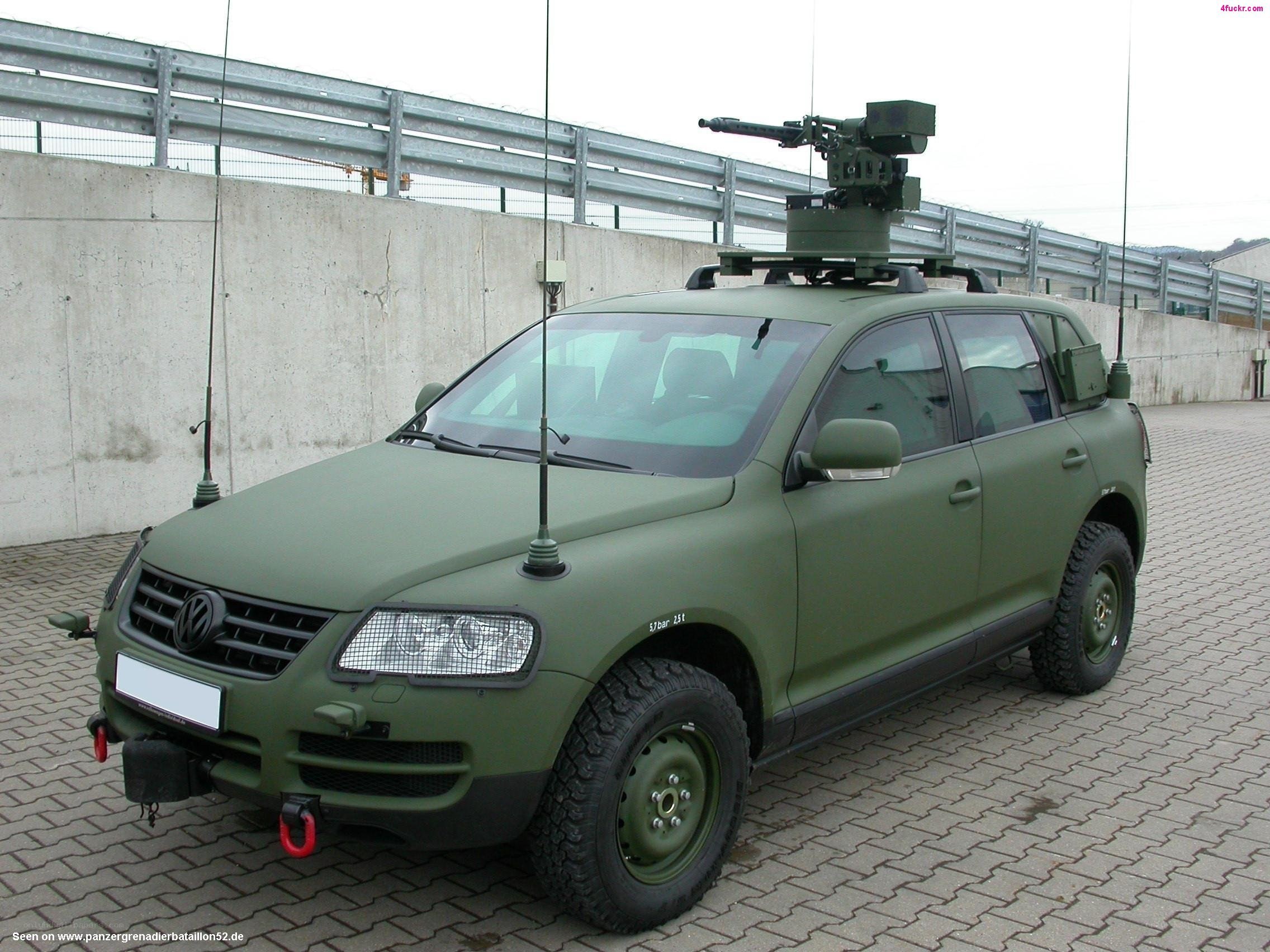 Military vehicle with mounted weapon