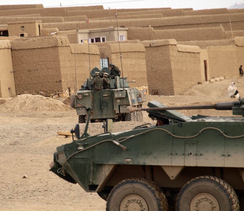 Military vehicles in a village