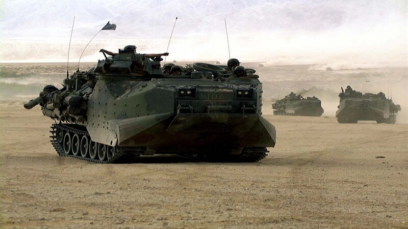 Military vehicles in desert convoy