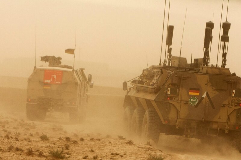 Military vehicles in desert dust