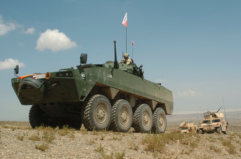 Military vehicles in desert terrain