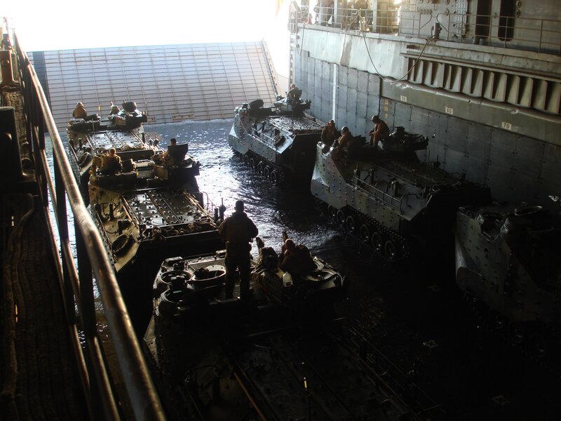 Military vehicles loading onto ship