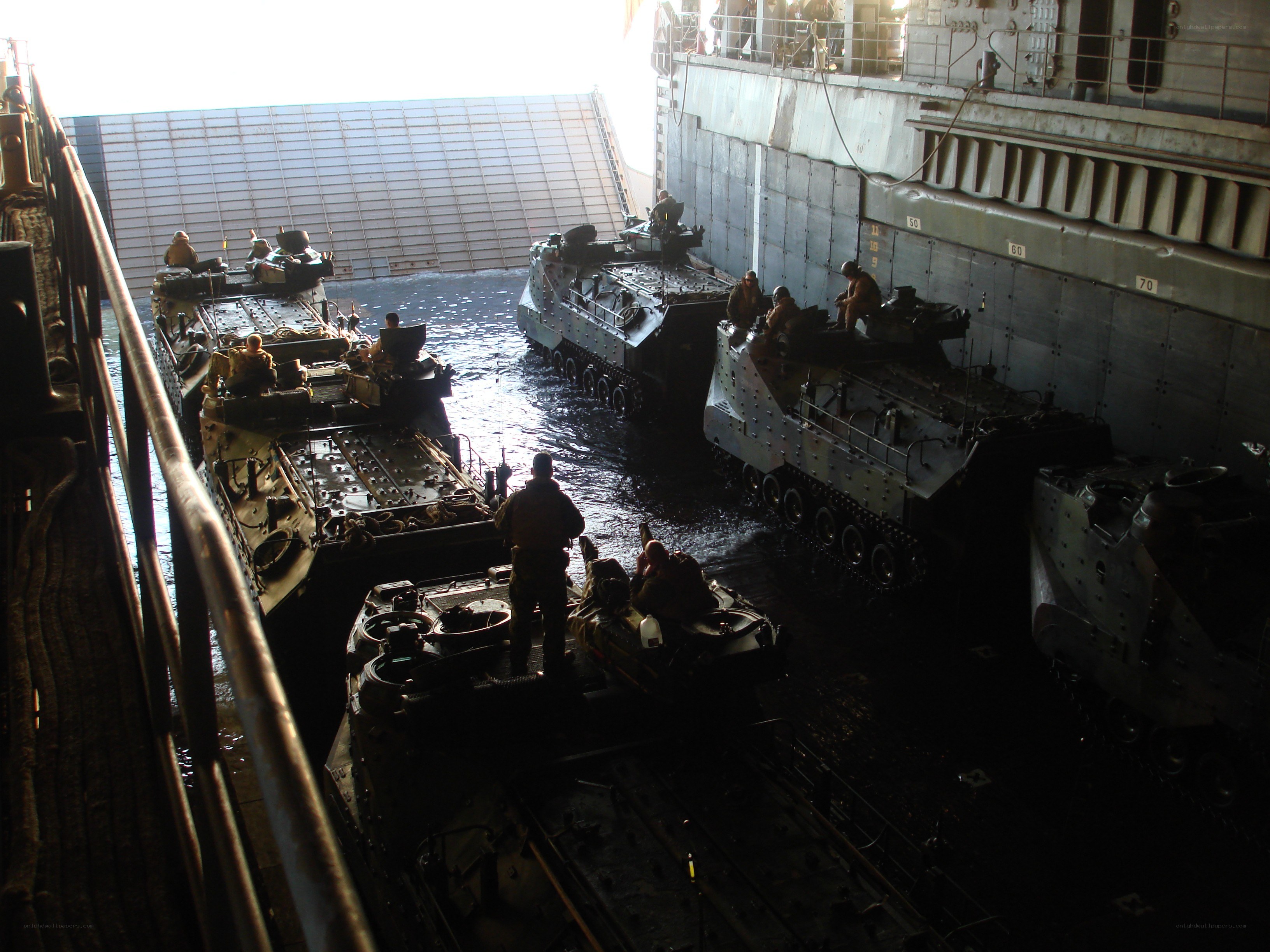 Military vehicles loading onto ship