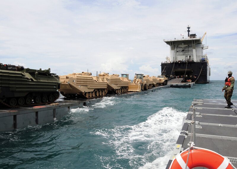Military vehicles loading onto ship