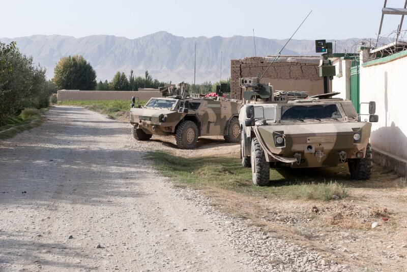 Military vehicles on a dirt road