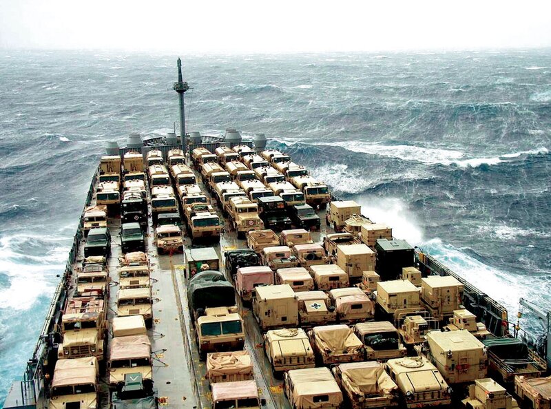 Military vehicles on a ship in rough seas