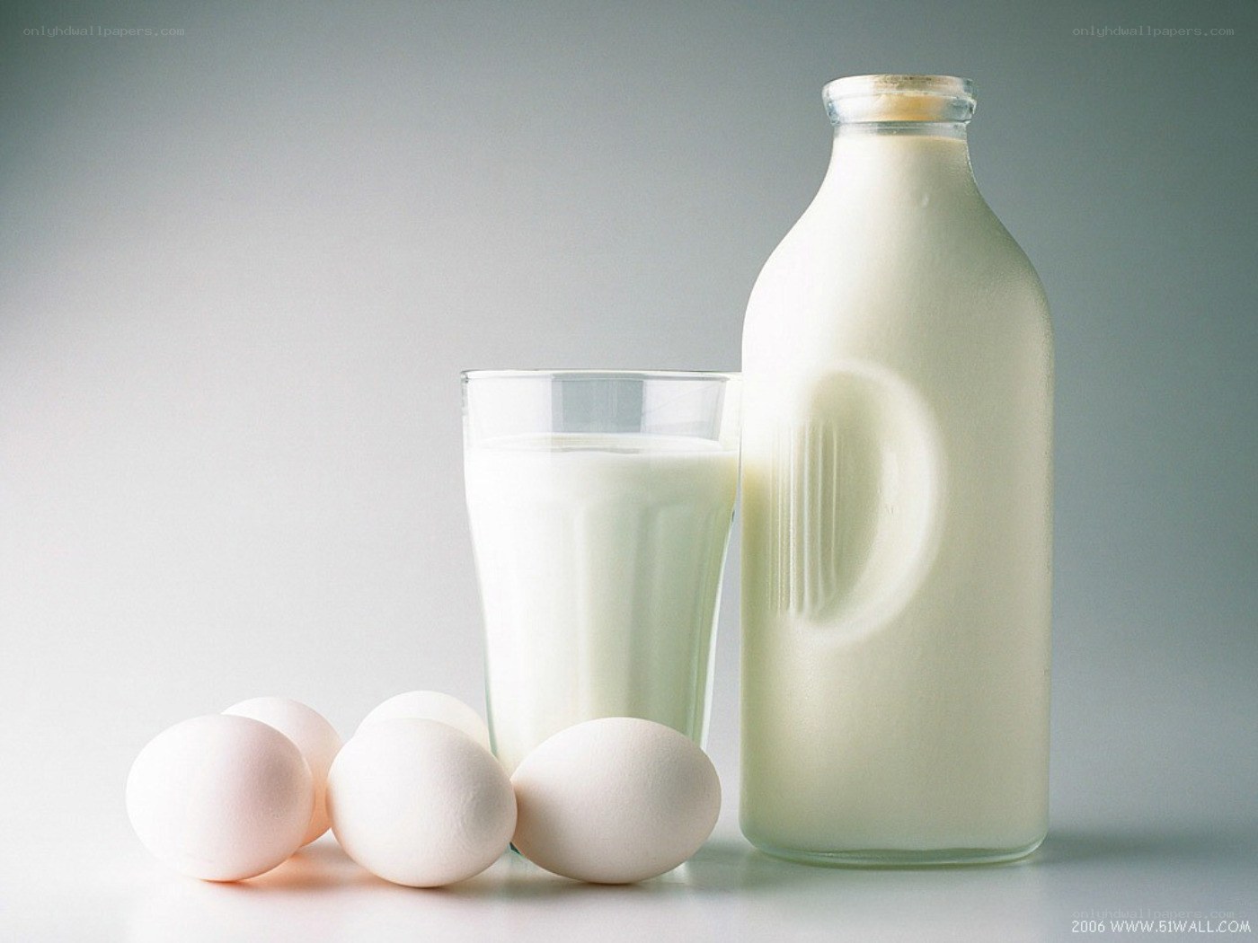 Milk and eggs on white