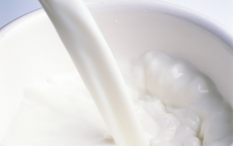 milk being poured into a bowl