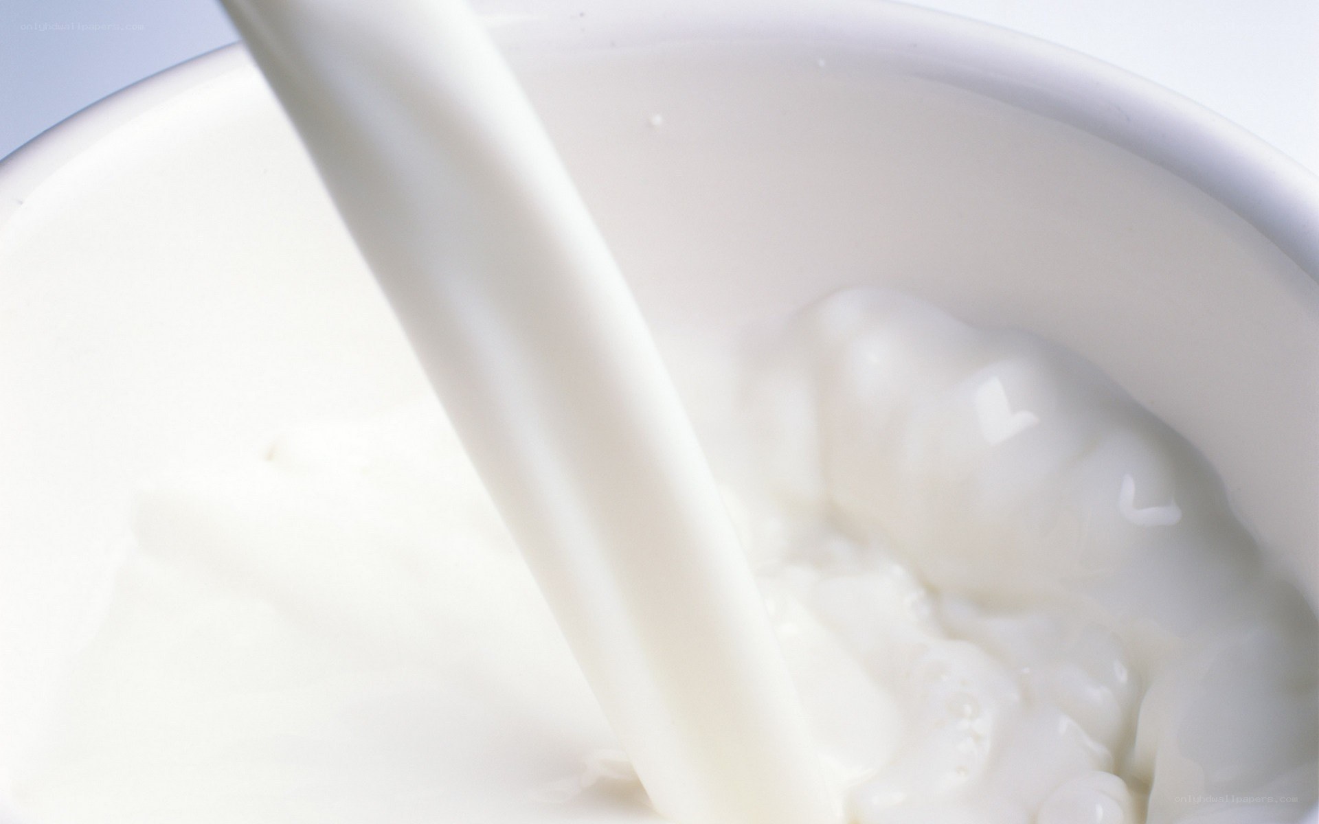 milk being poured into a bowl