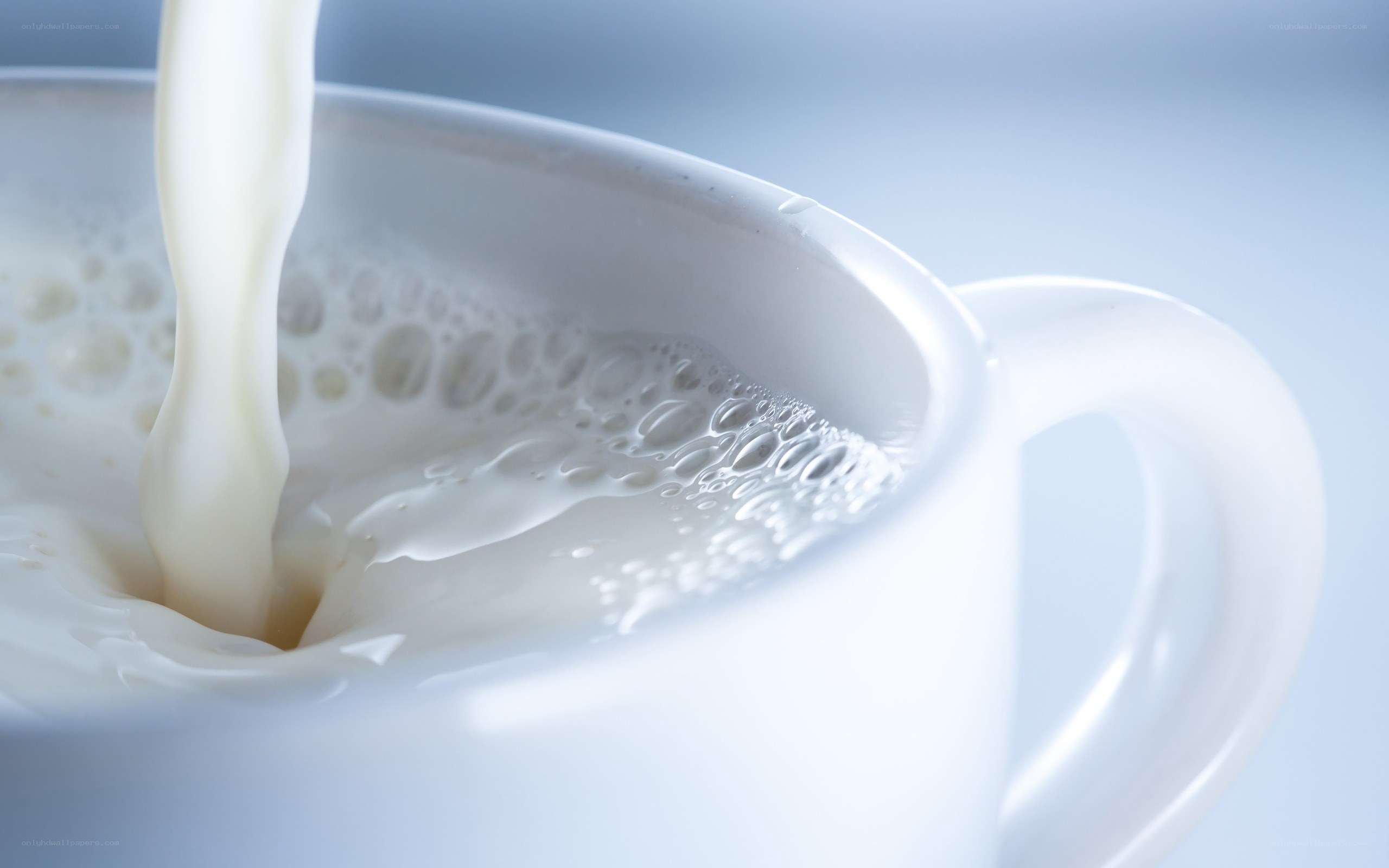 milk being poured into a cup