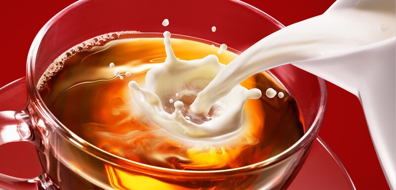 milk being poured into tea