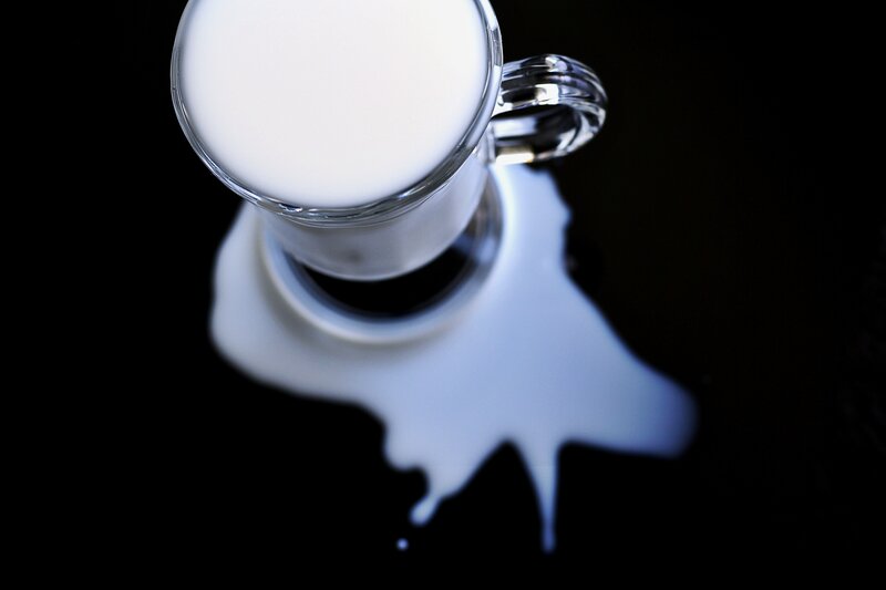milk spill on black surface