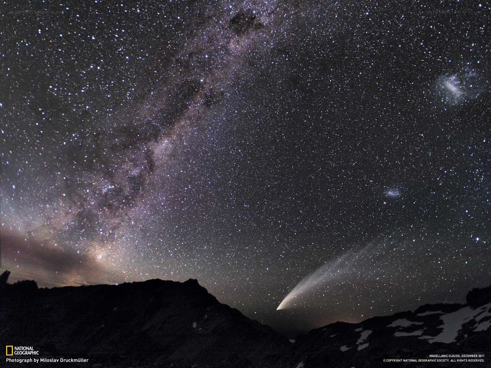 Milky Way and comet over mountains