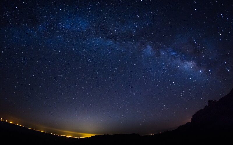 Milky Way over a dark landscape