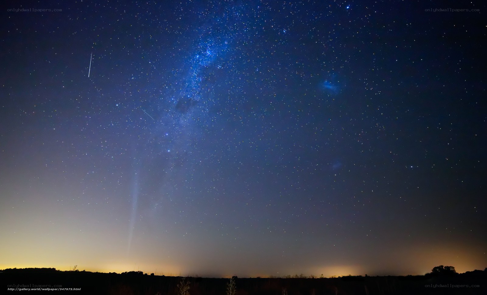 Milky Way over a dark landscape