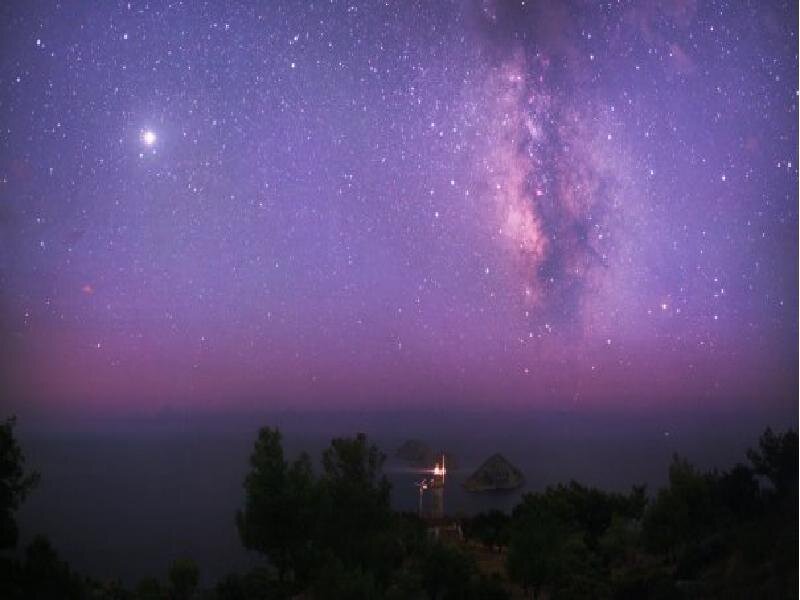 Milky Way over coastal lighthouse