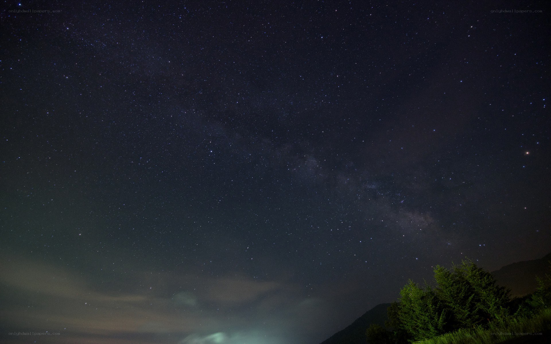 Milky Way over forested hills