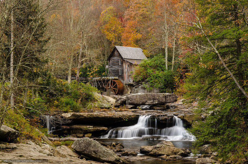 Mill by a waterfall in autumn