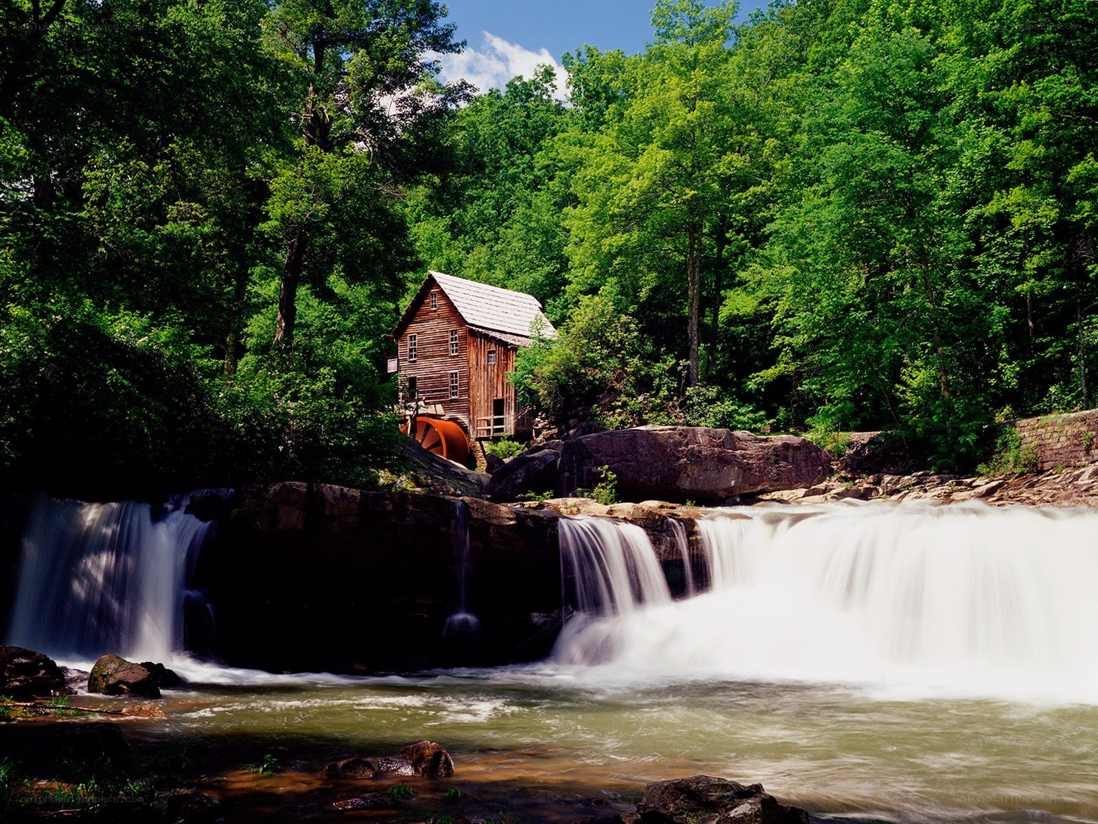 Mill by a waterfall in the forest