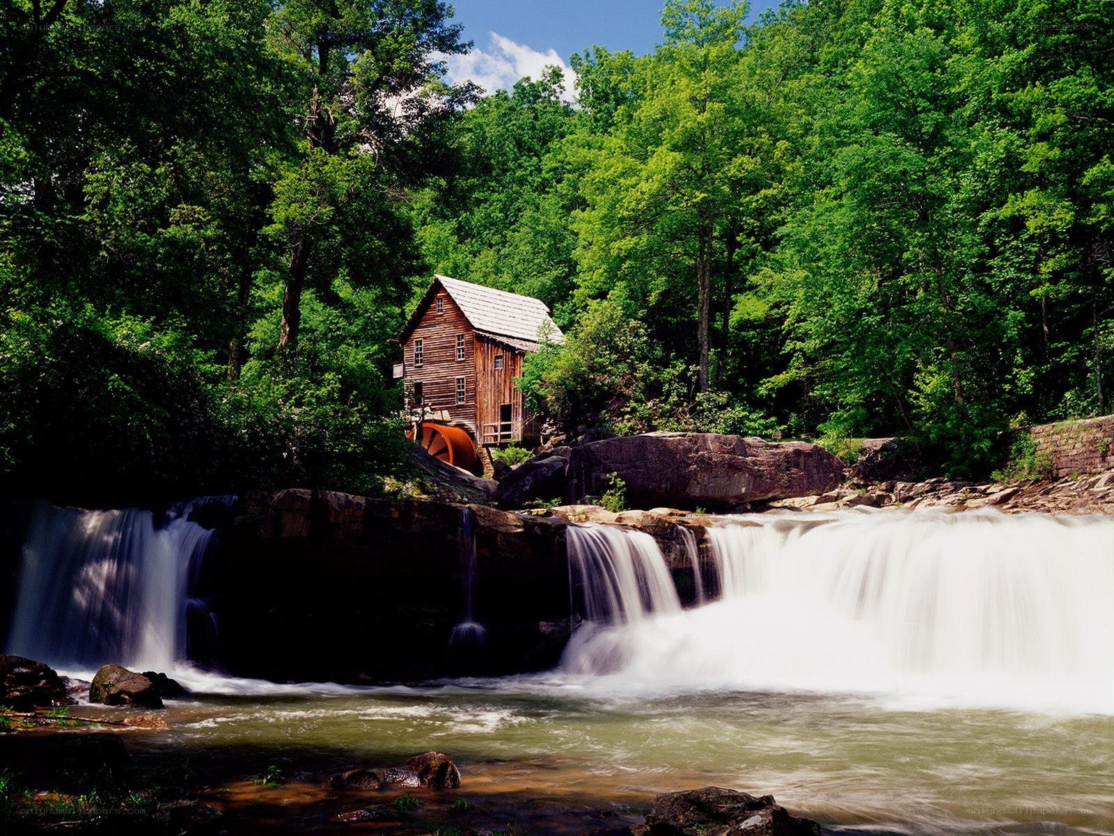 Mill by a waterfall in the forest