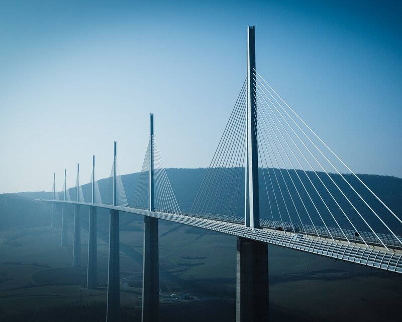 Millau Viaduct Bridge — Blue, Serene, Afternoon, Photograph, Hills, Sky, Gray