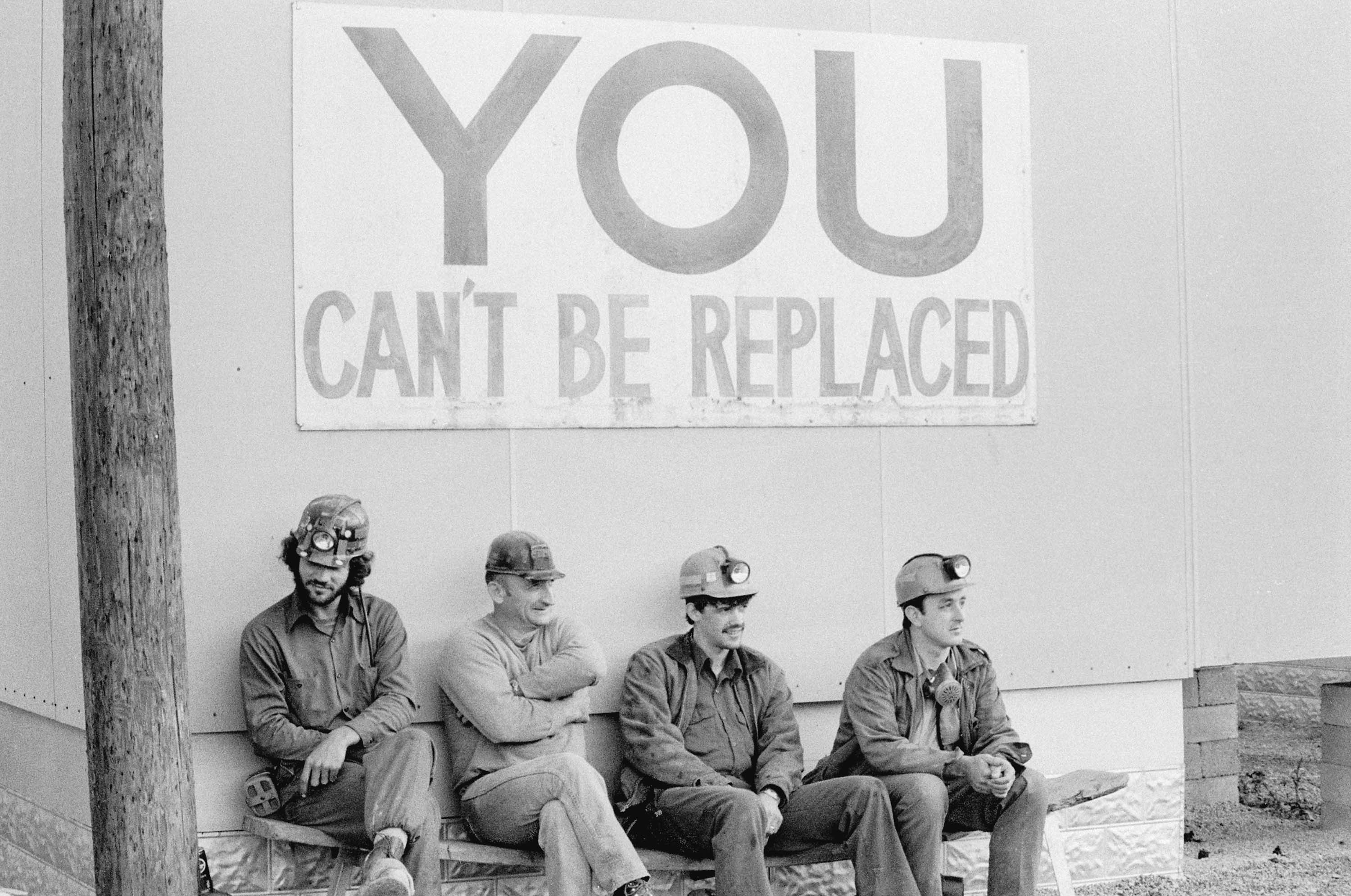 Miners with sign
