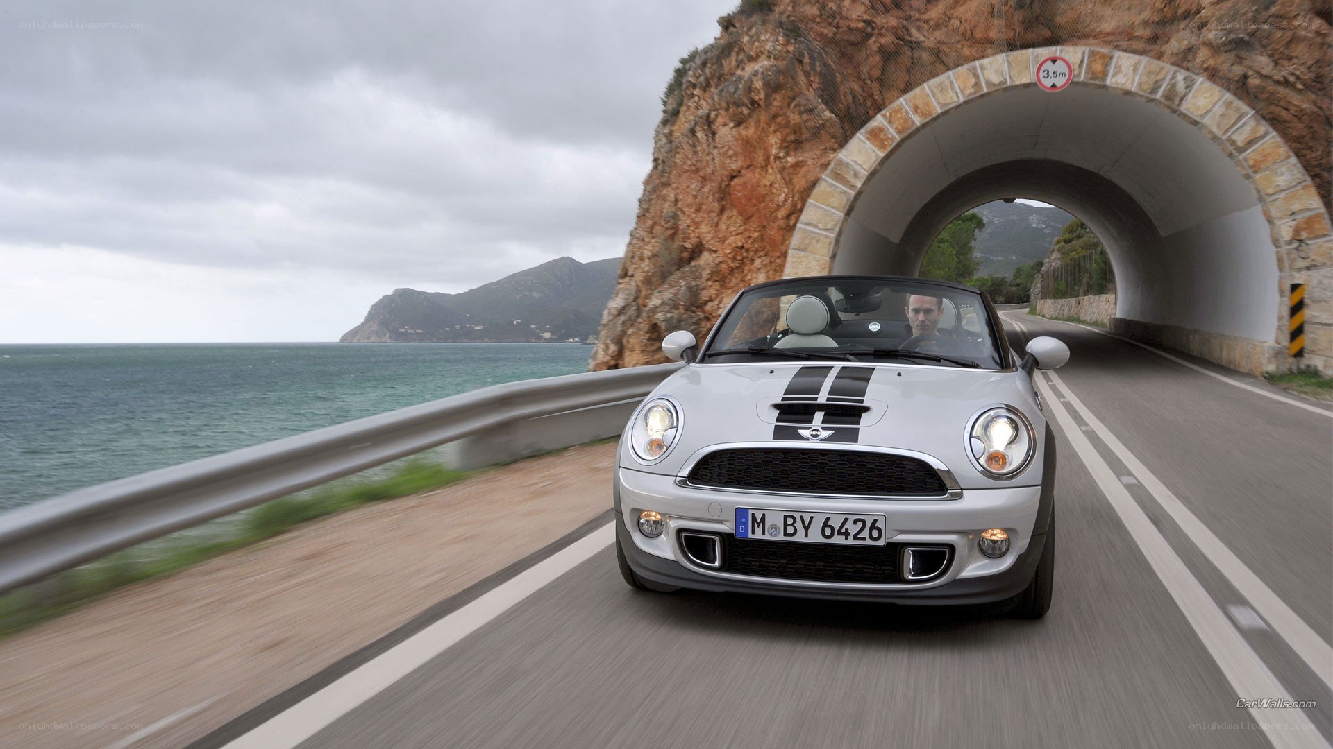Mini Cooper driving on coastal road