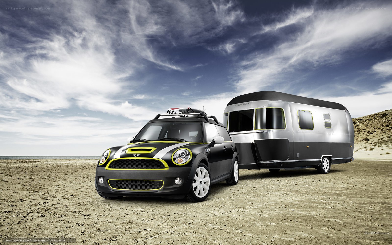 Mini Cooper towing trailer on beach