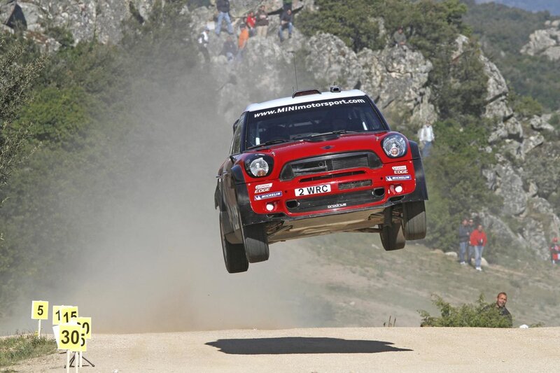 Mini rally car in mid-air jump