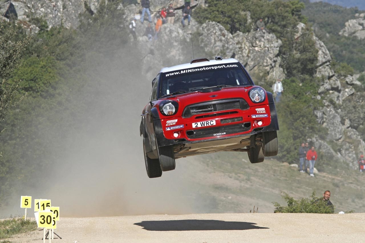 Mini rally car in mid-air jump